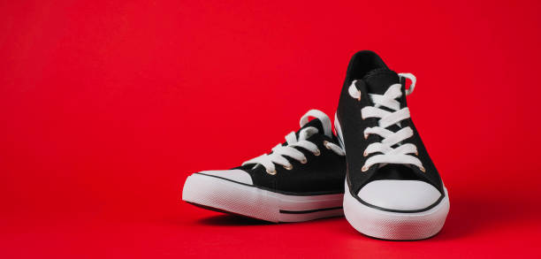 istock Sport sneakers on bright red background 1137113906