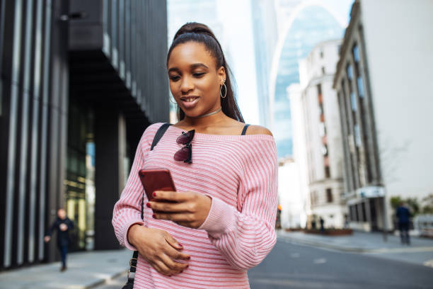 istock African student with backpack in Europe, using mobile phone 1137115085
