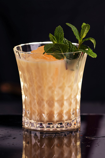 Batida cocktail drink with mint making by bartender