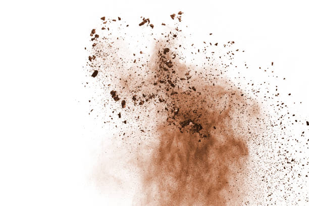 Brown color powder explosion on white background. Colored cloud. Colorful dust explode. Paint Holi.