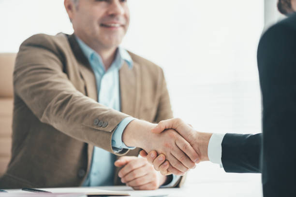 istock The two businessmen handshaking above the office table 1137116111