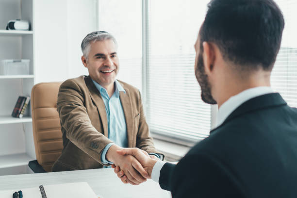 istock The two businessmen handshaking above the office table 1137116408