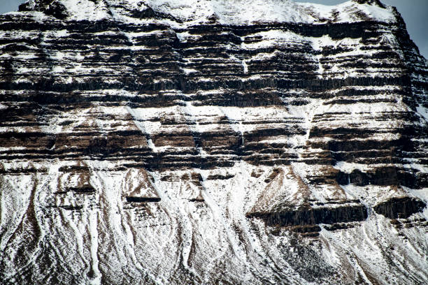 istock Volcanic mountain covered in layers of snow 1137119005