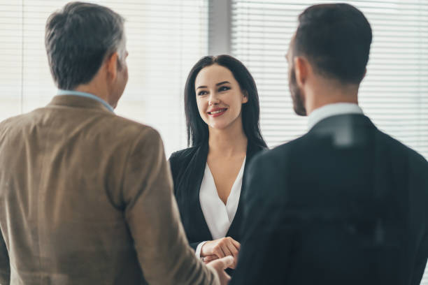 istock The three business people standing in the office 1137119899