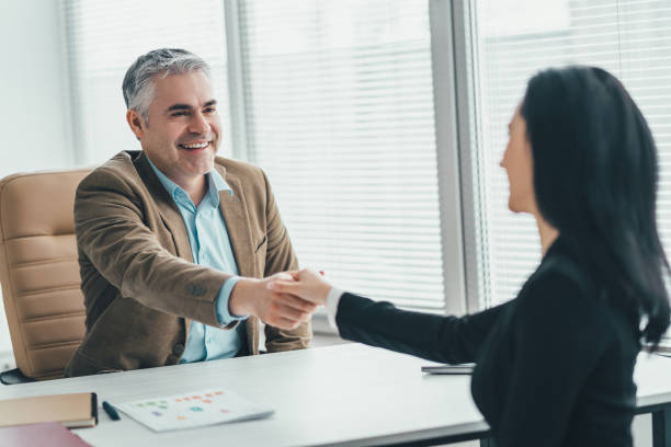 istock The two business people handshaking at the office table 1137119944