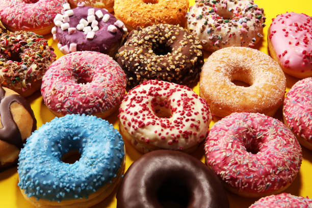 istock assorted donuts with chocolate frosted, pink glazed and sprinkles donuts 1137121347