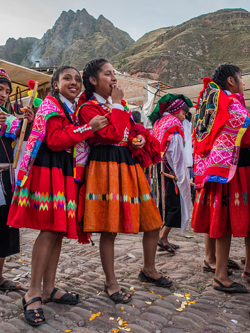 Pisac, Peru - May 19, 2016: Kids in colorful, folk costumes in the Pisac market. Latin America.Pisac, Peru - May 19, 2016: Kids in colorful, folk costumes in the Pisac market