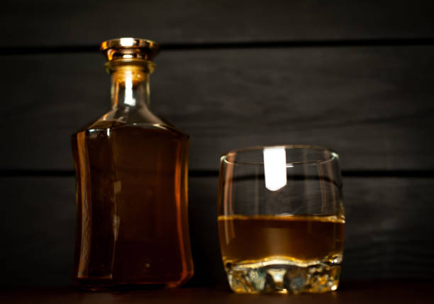istock whiskey bottle and whiskey glass on concrete background 1137123487