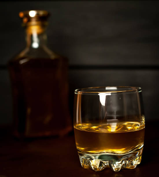 istock whiskey bottle and whiskey glass on concrete background 1137123494