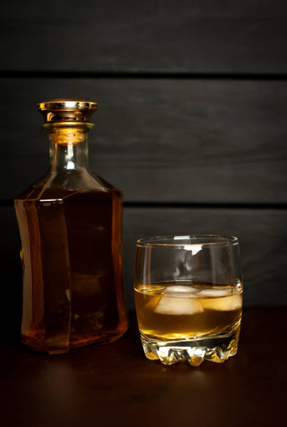 istock whiskey bottle and whiskey glass on concrete background 1137123507