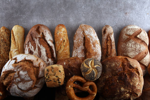 istock Assortment of baked bread and bread rolls on stone table background 1137124004