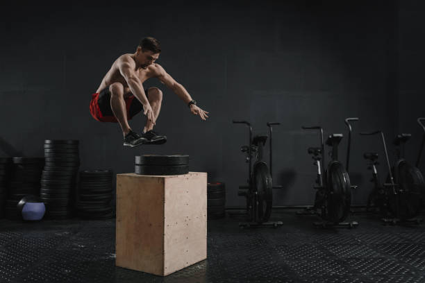 istock Young cross training athlete doing box jump exercise at the gym 1137124018
