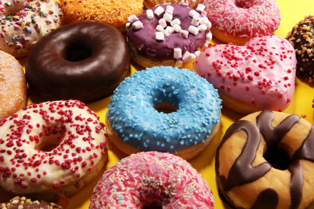 istock assorted donuts with chocolate frosted, pink glazed and sprinkles donuts 1137124589