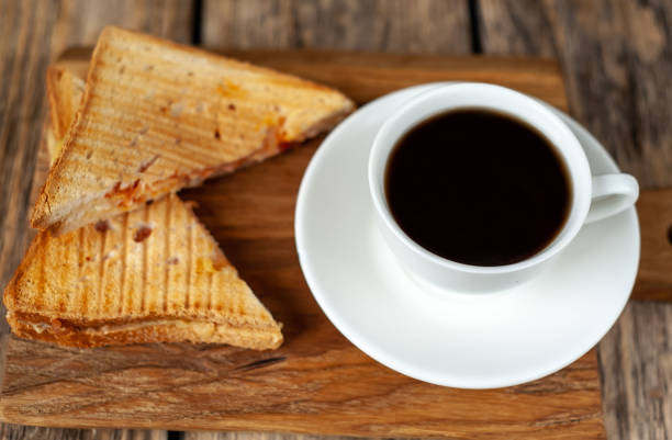 istock two sandwiches and coffee on a wood background 1137127899