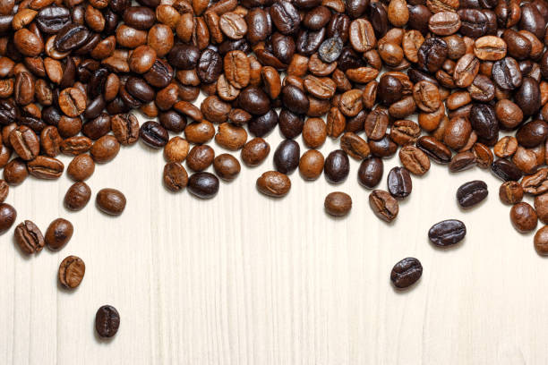 istock Coffee beans on a light wooden table 1137128330