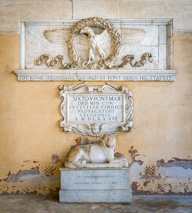 Roman empire eagle and stone lion, in the portico of the Basilica of the Santi XII Apostoli, in Rome, Italy.