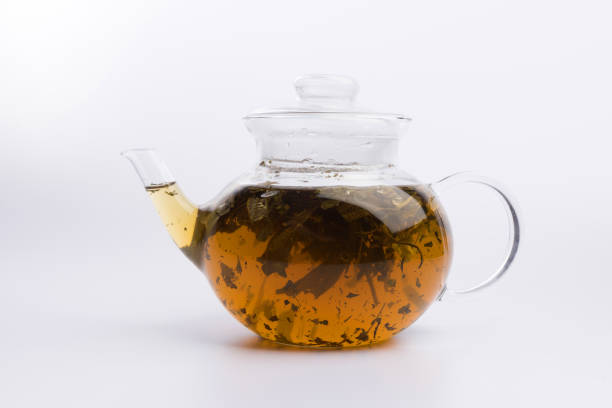 istock Herbal tea in a teapot with fresh herbs isolated on white background 1137132536