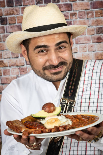 istock Colombian man holding a bandeja paisa (typical Colombian dish) 1137137285