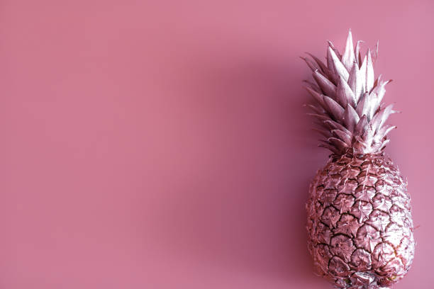 istock Gold colored pineapple on a colored background. Tropical flat lay. Food concept. 1137138793