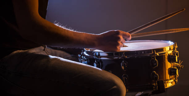 istock man playing the snare drum on a beautiful colored background 1137140699