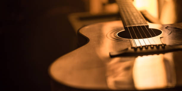 acoustic guitar close-up on a beautiful colored background acoustic guitar close-up on a beautiful colored background, the concept of stringed instruments acoustic music photos stock pictures, royalty-free photos & images
