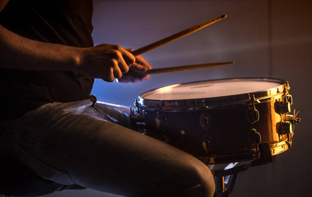 istock man playing the snare drum on a beautiful colored background 1137140720