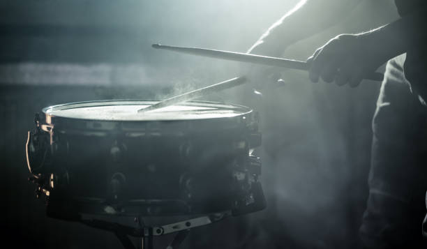 istock man playing the snare drum on a beautiful colored background 1137140723