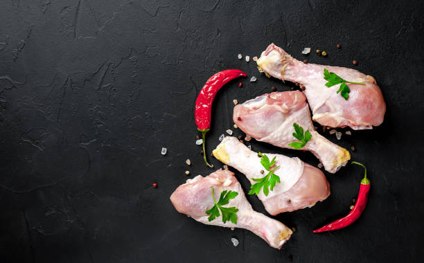 istock Chicken legs with spices, ready for cooking, background concrete 1137141111