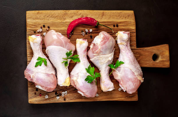istock Chicken legs with spices, ready for cooking on a cutting board, background concrete 1137141257
