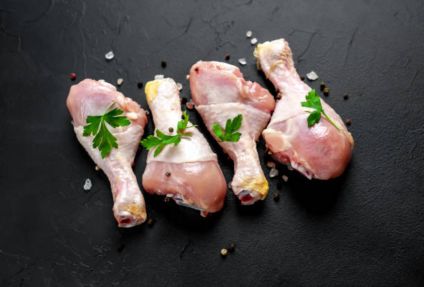 istock Chicken legs with spices, ready for cooking, background concrete 1137141293