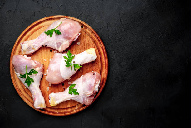 istock Chicken legs with spices, ready for cooking on a cutting board, background concrete 1137141308