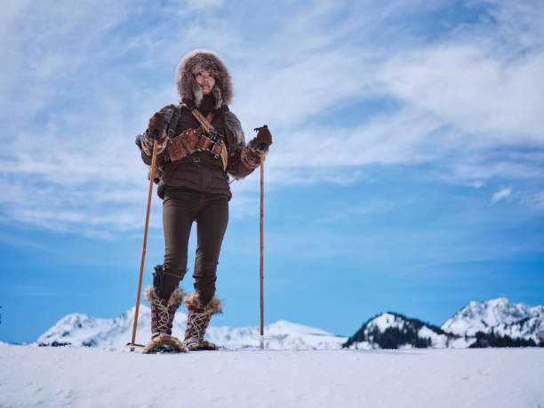 A Japanese woman wearing snowshoes, exploring the winter wilderness in the mountains.