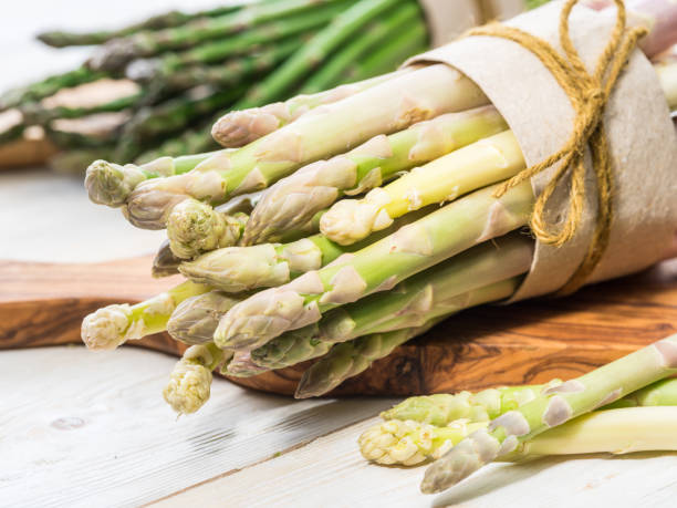 istock Bundles of green and white asparagus. 1137143902