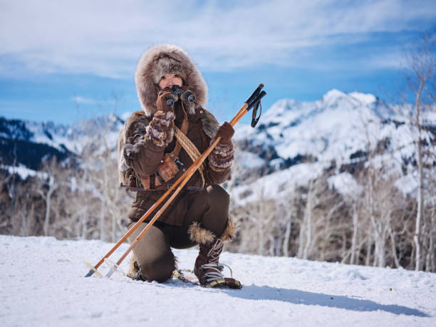 A Japanese woman wearing snowshoes, exploring the winter wilderness in the mountains.