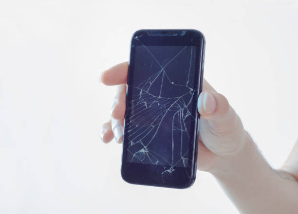 istock High angle view of unrecognizable person holding  broken smartphone over white background 1137151792