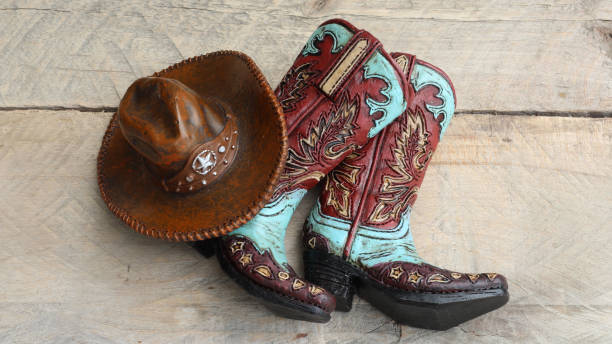 istock Cowboy boots and hat laying on a wood background 1137153758