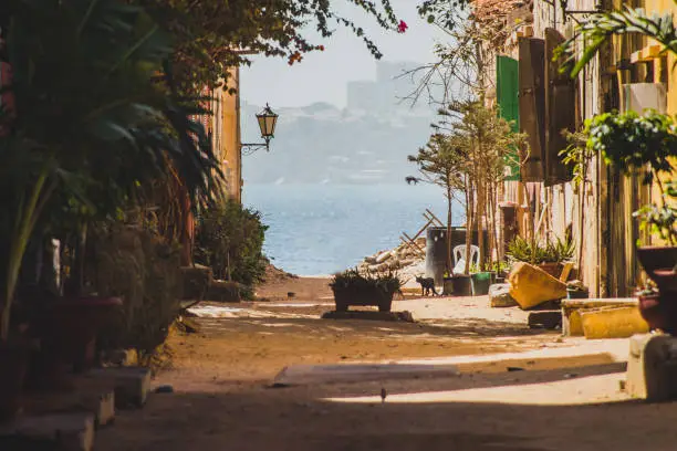 A view from one of the streets on Ille de Goree towards the city of Dakar. Beautiful street on the island of Goree, Senegal.