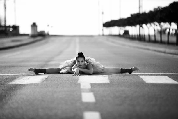Beautiful ballet dancer posing at street