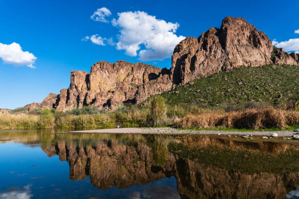 Scenic view of the Salt River with desert mountains reflecting in the water near Mesa, Arizona.