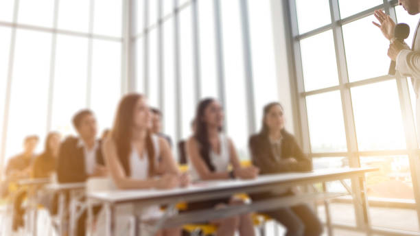 istock Business Trainer. side view of man gesturing with hand while standing Speaking in front of Audience sitting to listening coaching, Seminar Training Meeting Event of Entrepreneurs for Startup workshop. 1137185182