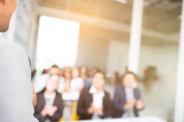 istock Business Training concept. rear view of coach while standing Speaking in front of Audience sitting to listening coaching, Seminar Training Meeting Event of Entrepreneurs for Startup workshop. 1137185318