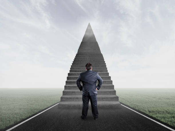 istock Businessman thinking and looking stairs 1137191530