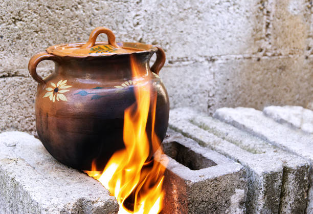 istock clay pot covered in brown, on gray brick fire, close-up 1137199602