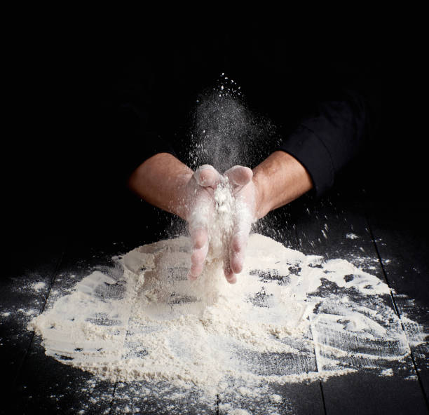 istock man's hands and splash of white wheat flour 1137205238