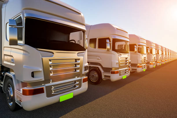 istock Row of cargo electric trucks against with sun 1137206010