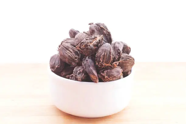Black cardamom kept in a Bowl with background-Image