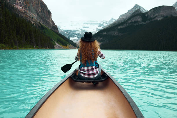 istock Young woman traveller on canoe enjoying nature views 1137213556