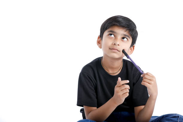 cute indian boy thinking idea and looking at up, isolated on white background - facial expression child asia asian and indian ethnicities imagens e fotografias de stock