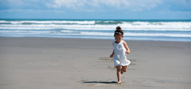 istock Toddler girl playing on the beach 1137225439
