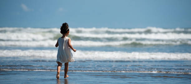 istock Toddler girl playing on the beach 1137225445